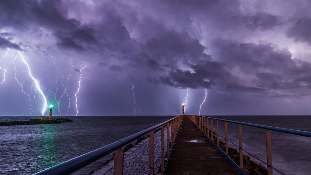 lightning striking through dark storm clouds