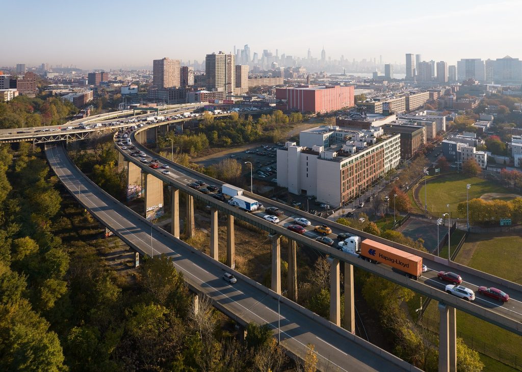 An aerial view of traffic moving through a large city road junction.