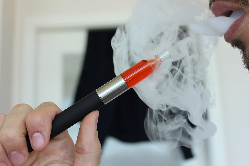 Clinical-style illustration with a stethoscope, lungs and a vapour device